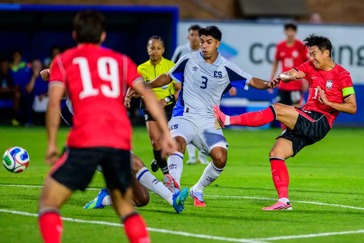 South Korea forward Son Heung-Min, right, shoots the ball during the second half of an international friendly soccer match against El Salvador, Wednesday, June 3, 2026, in Provo, Utah. (AP Photo/Tyler Tate)