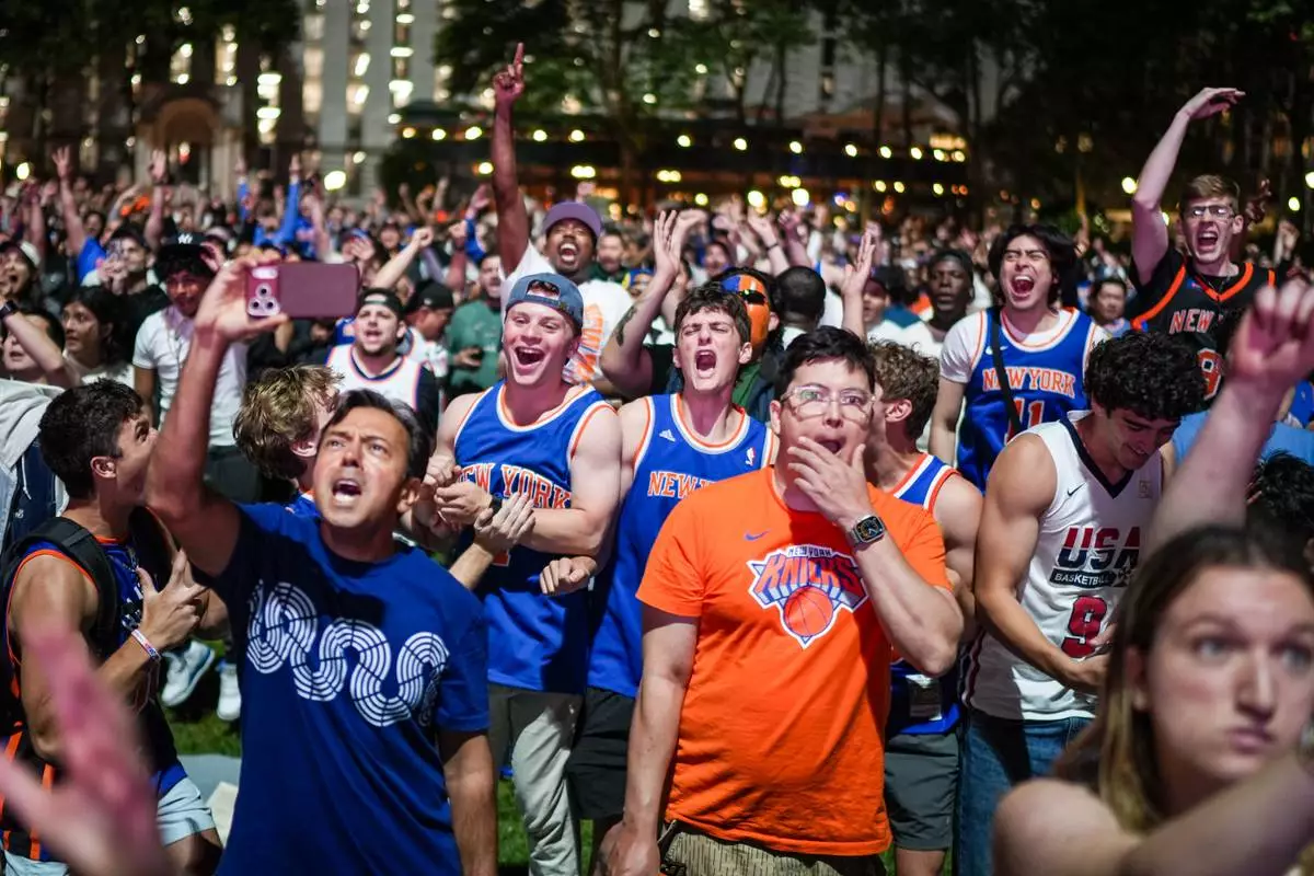 New York Knicks fans cheer at a watch party during Game 3 of the NBA Finals basketball series between the Knicks and the San Antonio Spurs, Monday, June 8, 2026, in New York. (AP Photo/Ryan Murphy)