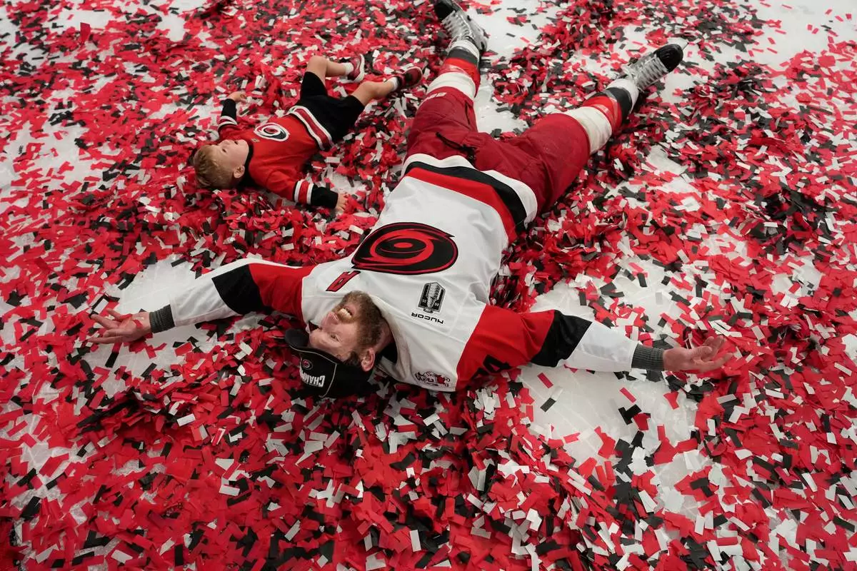 Carolina Hurricanes defenseman Jaccob Slavin (74) celebrates on the ice after a win over the Vegas Golden Knights in Game 6 of the NHL hockey Stanley Cup Final series, Sunday, June 14, 2026, in Las Vegas. (AP Photo/John Locher)