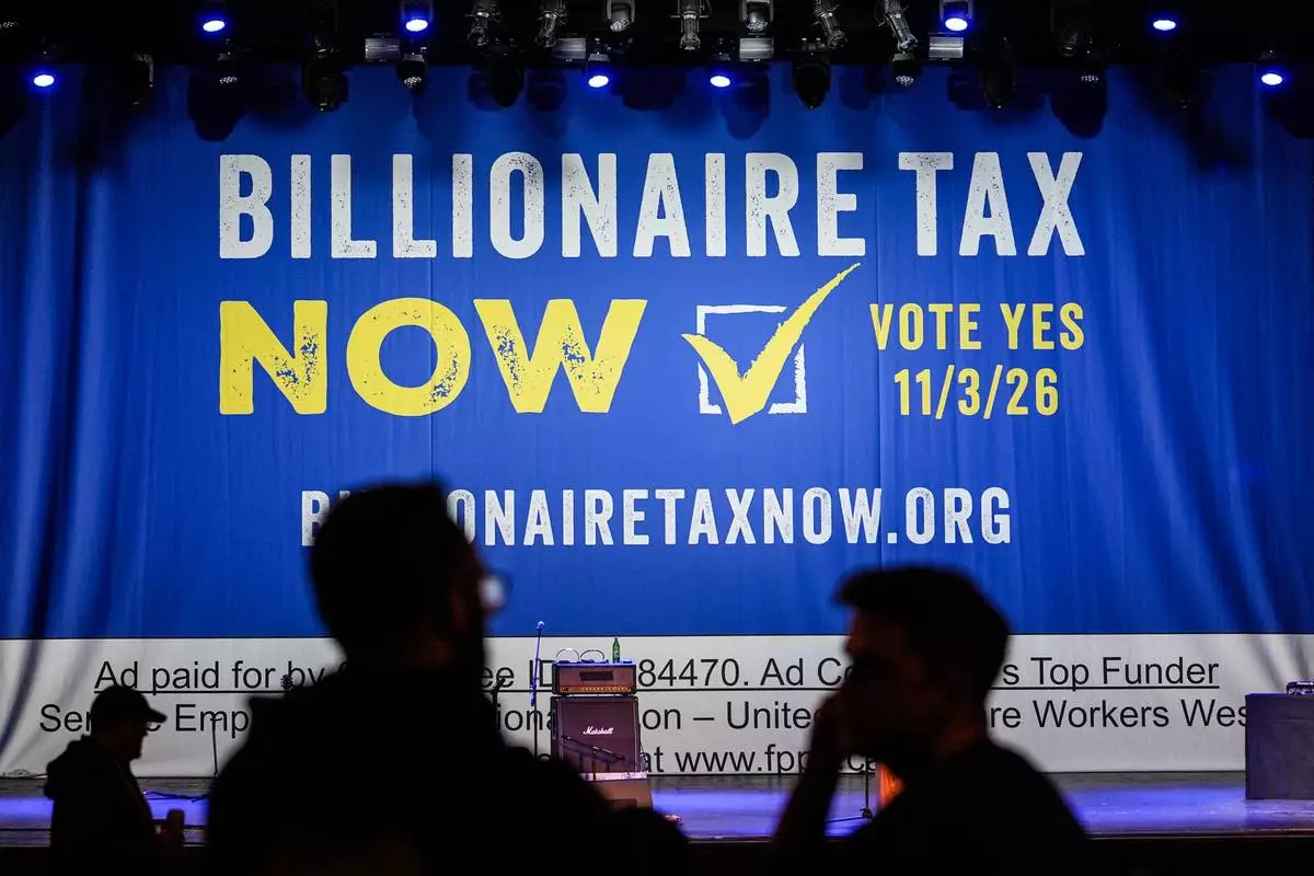 FILE - A large banner is seen at a campaign event for a proposed "billionaires tax" in Los Angeles on Feb. 18, 2026. (AP Photo/Jae C. Hong, File)