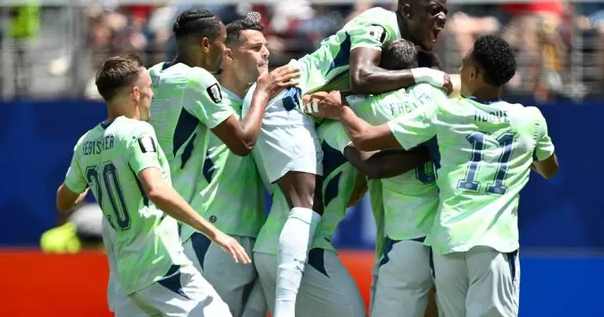 Boualem Khoukhi's goal on header in stoppage time earns Qatar a 1-1 World Cup draw with Switzerland