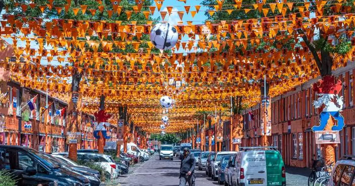 A street in The Hague is drenched in orange as Netherlands soccer fans celebrate the World Cup