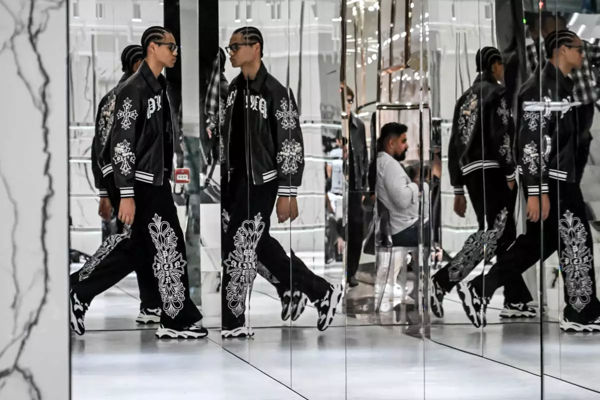 Models wear creations from the Philipp Plein's Spring/Summer 2027 Men's collection presented in Milan, Italy, Saturday, June 20, 2026. (AP Photo/Nicola Marfisi)