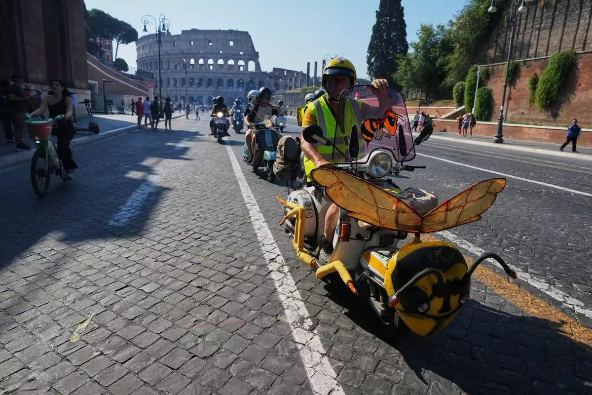 Vespa enthusiasts parade during celebrations for the 80th anniversary of the Vespa scooter, in Rome, Saturday, June 27, 2026. (AP Photo/Alessandra Tarantino)