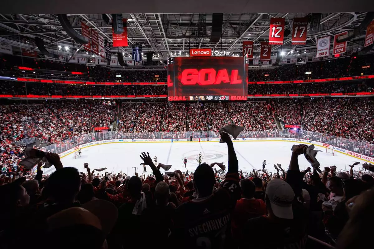 Carolina Hurricanes fans react after a goal against the Vegas Golden Knights during the second period of Game 5 of the NHL hockey Stanley Cup Final series in Raleigh, N.C., Thursday, June 11, 2026. (AP Photo/Ben McKeown)