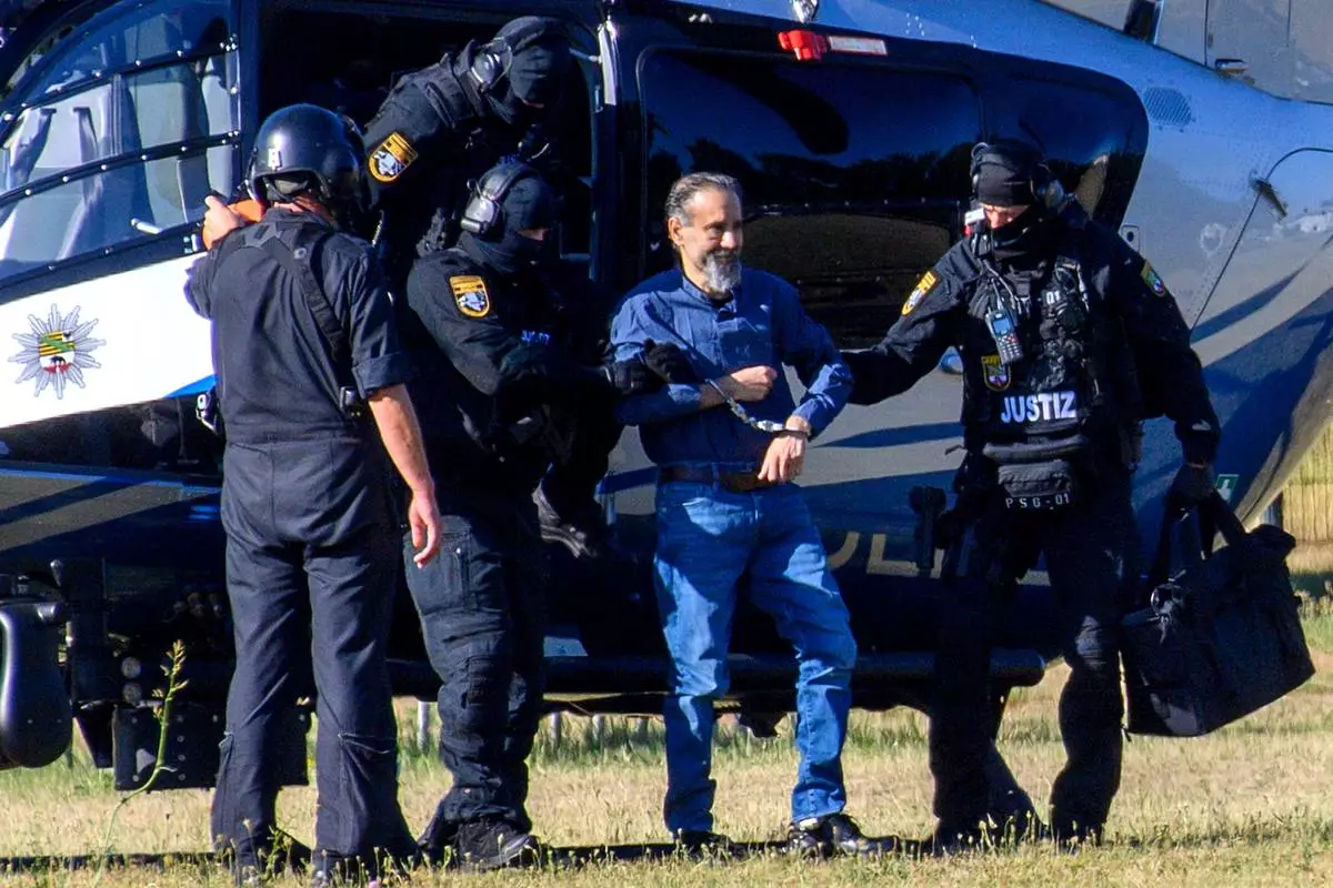 The defendant, Taleb al-Abdulmohsen, second right, arrives at the court in Magdeburg, Germany, Friday, June 26, 2026. (Klaus-Dietmar Gabbert/dpa via AP)