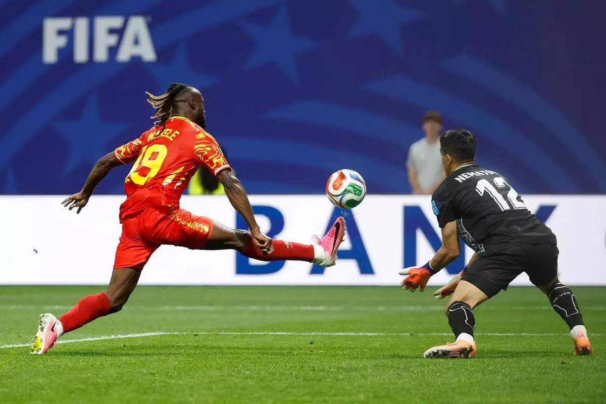 Congo's Fiston Mayele (19) scores their second goal against Uzbekistan goalkeeper Abduvohid Nematov (12) during the World Cup Group K soccer match between DR Congo and Uzbekistan in Atlanta, Saturday, June 27, 2026. (AP Photo/Erik S. Lesser)