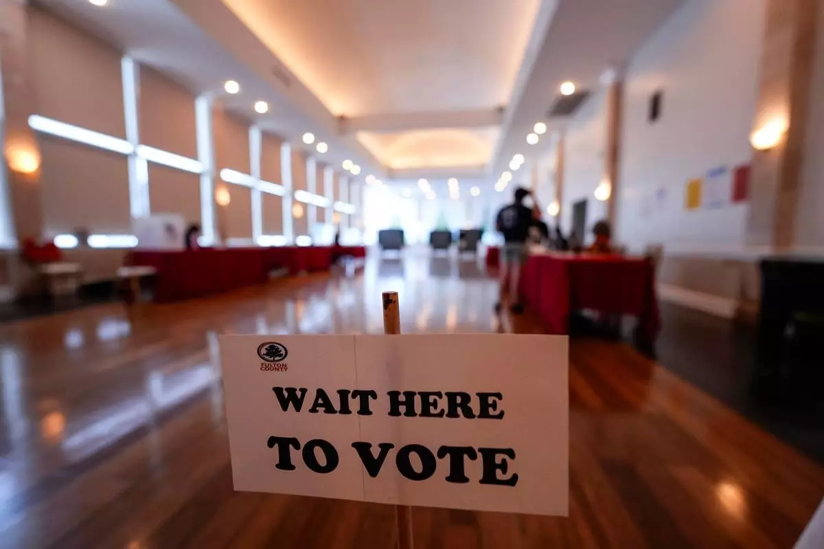 People vote in a runoff election at Park Tavern, Tuesday, June 16, 2026, in Atlanta. (AP Photo/Mike Stewart)