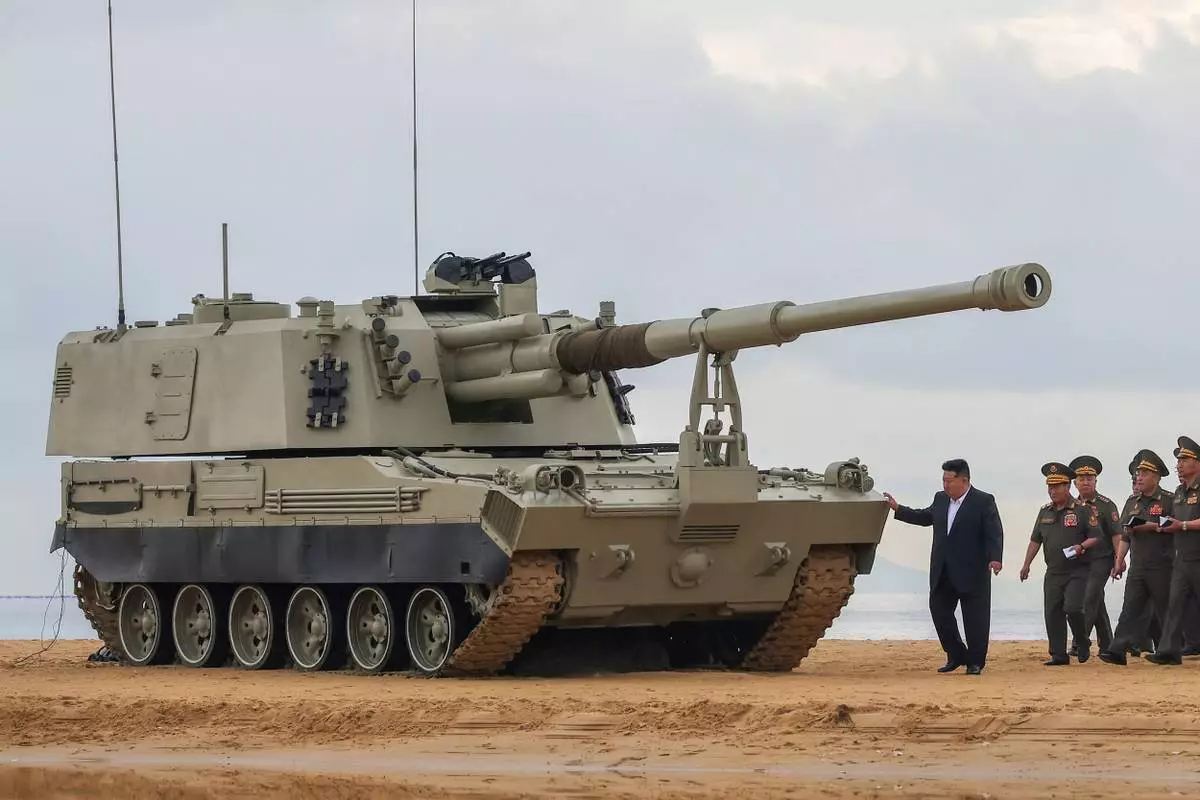 In this photo provided Friday, June 26, 2026, by the North Korean government, its leader Kim Jong Un, center right, visits the site of weapon tests at an undisclosed location, North Korea, Thursday, June 25, 2026. Independent journalists were not given access to cover the event depicted in this image distributed by the North Korean government. The content of this image is as provided and cannot be independently verified. (Korean Central News Agency/Korea News Service via AP)