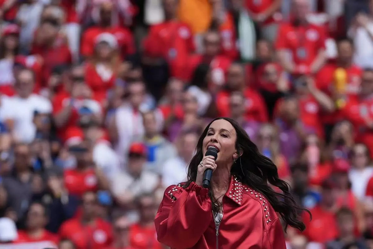 Alanis Morissette performs the Canadian national anthem during the World Cup Group B soccer match between Canada and Bosnia in Toronto, Friday, June 12, 2026. (AP Photo/Stephanie Scarbrough) CORRECTION: Corrects spelling of last name to Morissette, not Morisette