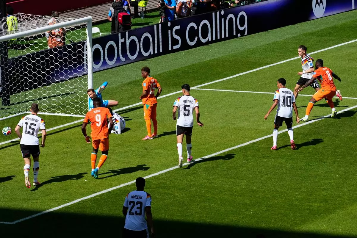 Ivory Coast's Franck Kessie, right scores their first goal past Germany goalkeeper Manuel Neuer (1) during the World Cup Group E soccer match between Germany and Ivory Coast in Toronto, Saturday, June 20, 2026. (Chris Young/The Canadian Press via AP)