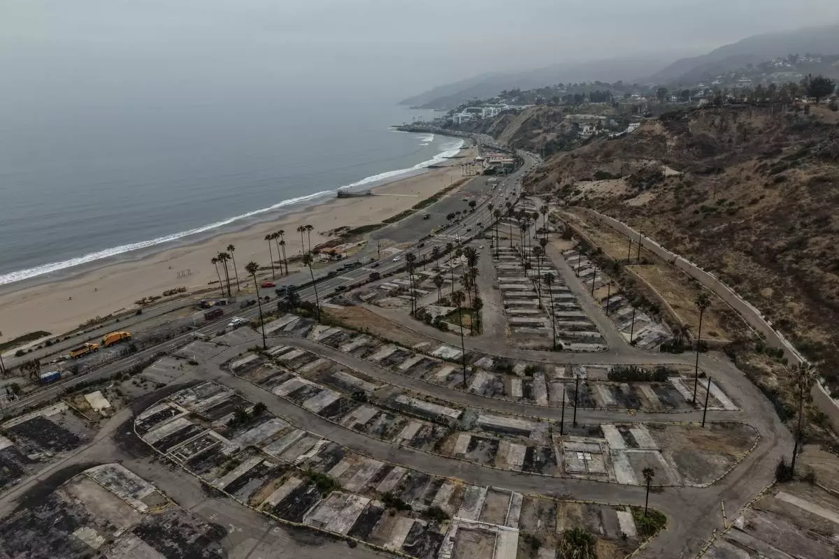 An aerial view shows the cleared site of a mobile home park more than a year after the Palisades Fire in the Pacific Palisades neighborhood of Los Angeles, Thursday, June 4, 2026. (AP Photo/Jae C. Hong)