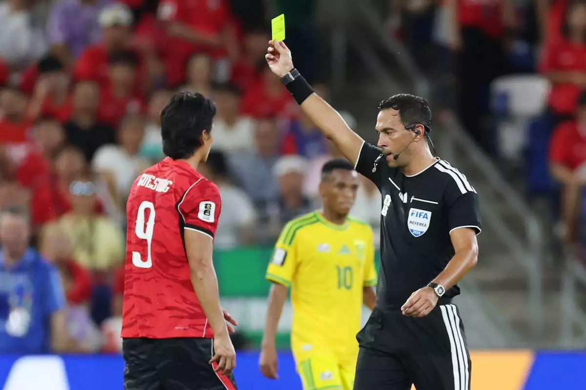 Referee Facundo Tello, of Argentina, issues a yellow card South Korea's Cho Gue-sung (9) during the World Cup Group A soccer match between South Africa and South Korea in Guadalupe, near Monterrey, Mexico, Wednesday, June 24, 2026. (AP Photo/Sofia Yaker)