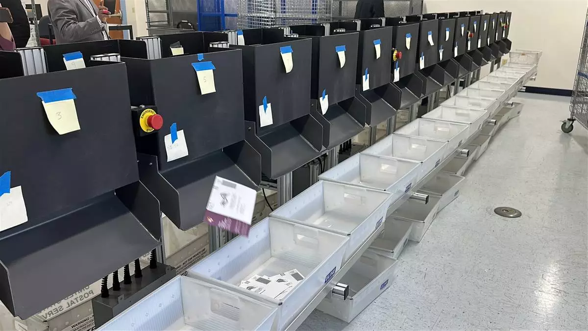 A sorting machine separates sample ballots into bins during a demonstration of voting equipment at the Montgomery County Board of Elections headquarters in Gaithersburg, Md., Thursday, Jan. 22, 2026. (AP Photo/Robert Yoon)