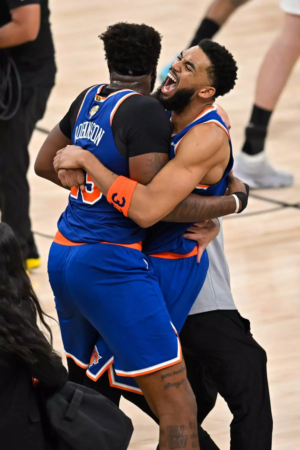 New York Knicks center Karl-Anthony Towns, right, hugs forward Og Anunoby during the after defeating the San Antonio Spurs in Game 5 of the NBA Finals basketball series, Saturday, June 13, 2026, in San Antonio. (AP Photo/Darren Abate)