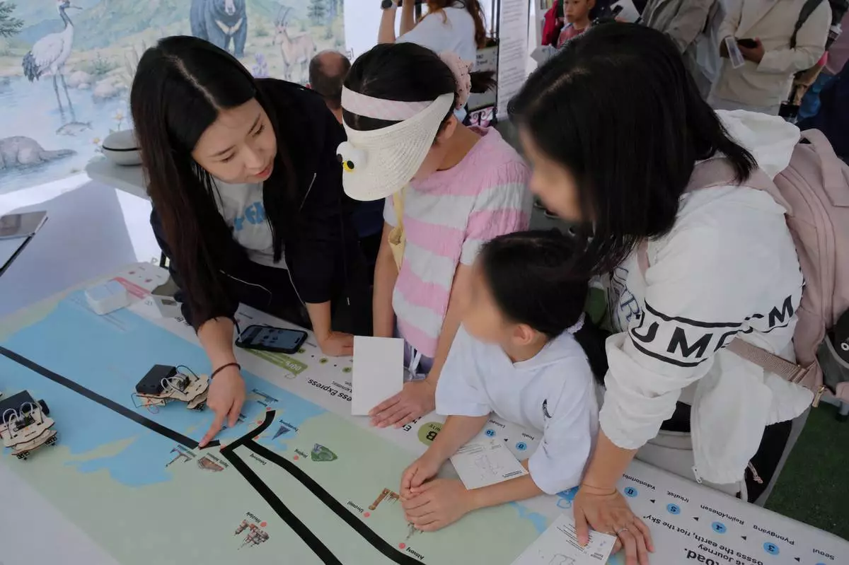 Visitors participate in the Line Tracer experience, exploring the economic and environmental potential of a peace-connected railway across the Korean Peninsula. (Image: Ministry of Unification)
