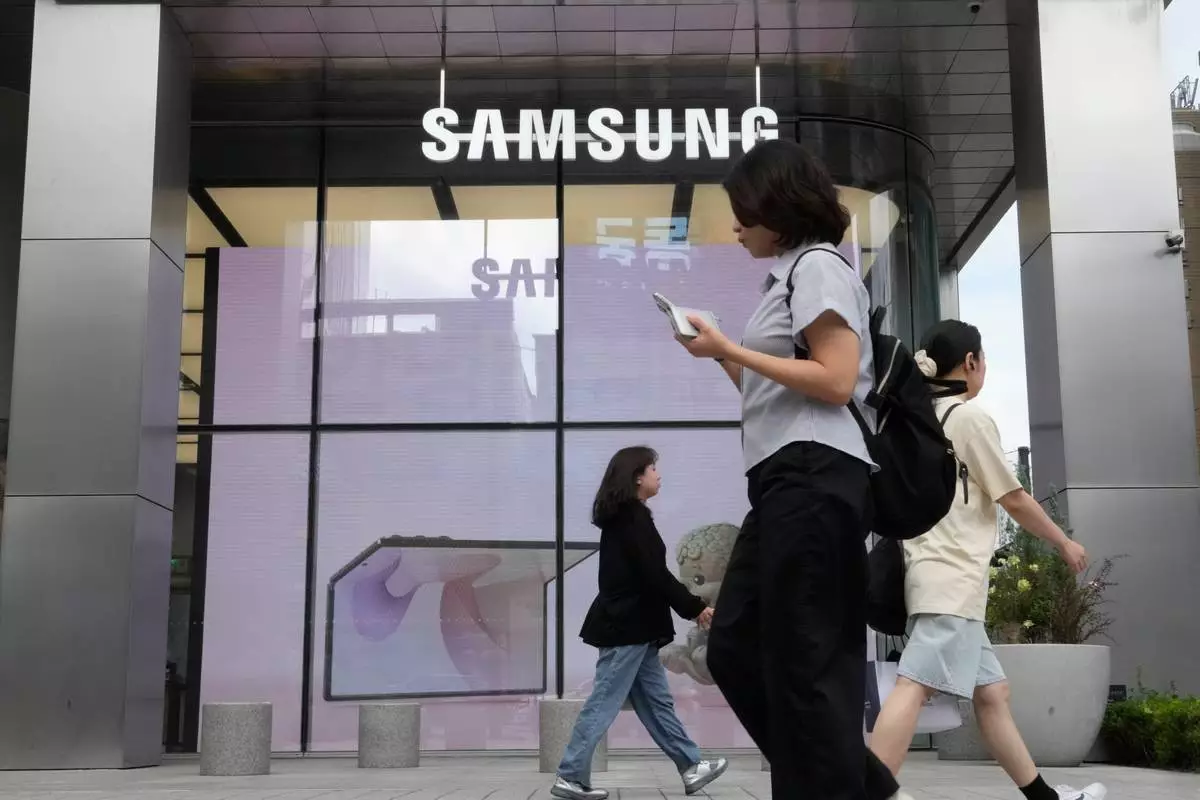 People pass by Samsung Gangnam store in Seoul, South Korea, Thursday, July 30, 2026. (AP Photo/Ahn Young-joon)