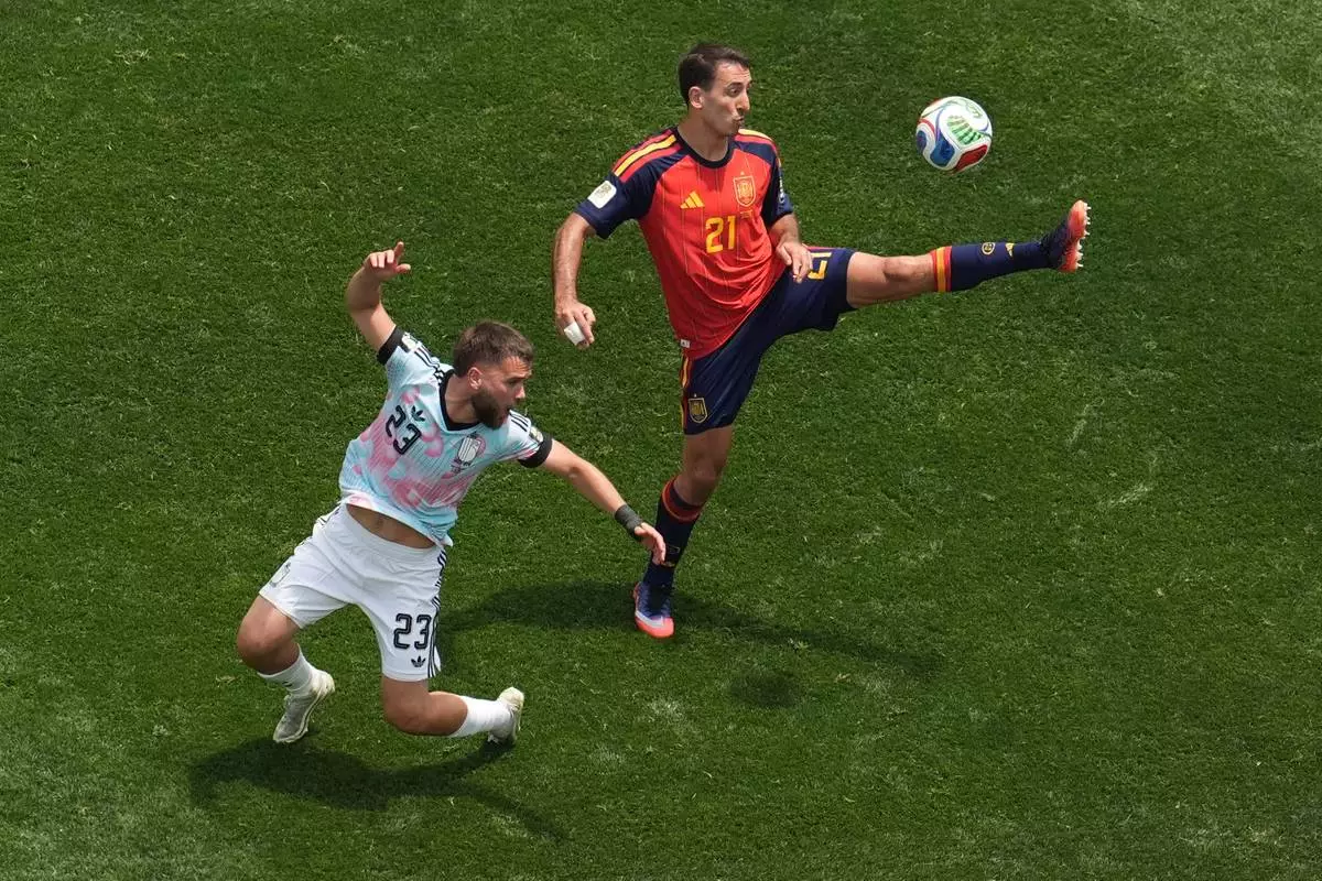 Spain's Mikel Oyarzabal (21) reaches for the ball behind Belgium's Nicolas Raskin (23) during the World Cup quarterfinal soccer match between Spain and Belgium in Inglewood, Calif., near Los Angeles, Friday, July 10, 2026. (AP Photo/Marcio J. Sanchez)