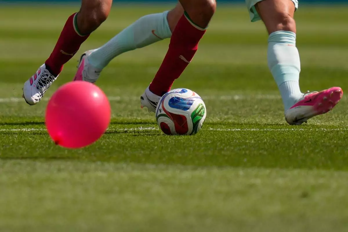 A balloon floats on the field as Morocco's Ayyoub Bouaddi, left, battles for the ball with France's Adrien Rabiot during the World Cup quarterfinal soccer match between France and Morocco in Foxborough, Mass., near Boston, Thursday, July 9, 2026. (AP Photo/Charles Krupa)