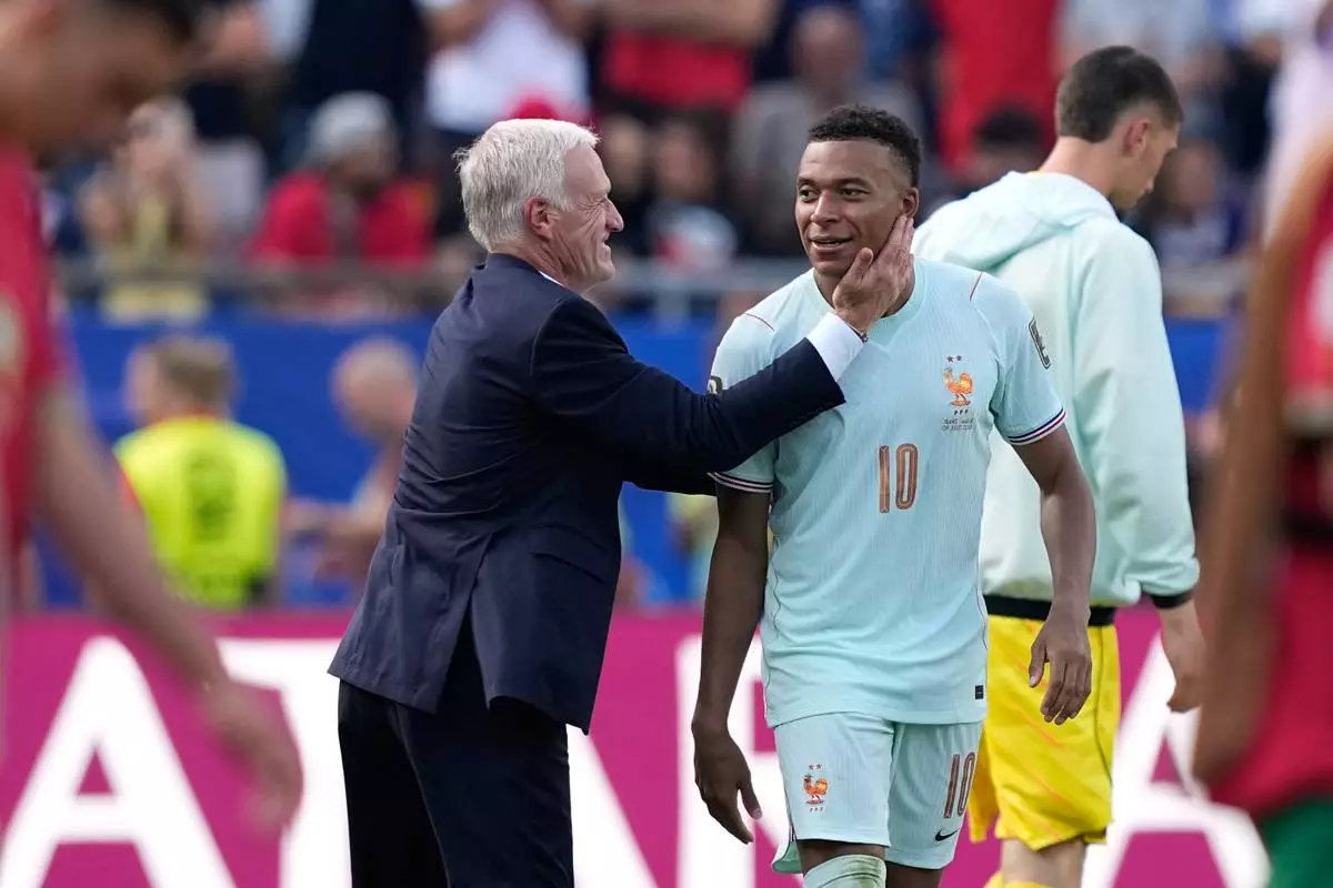 France head coach Didier Deschamps celebrates with France's Kylian Mbappe at the end of the World Cup quarterfinal soccer match between France and Morocco in Foxborough, Mass., near Boston, Thursday, July 9, 2026. (AP Photo/Matt Slocum)
