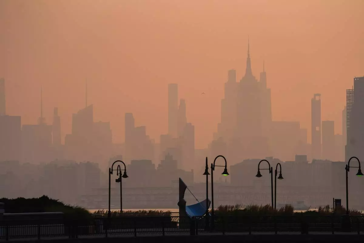 The New York City skyline is seen through a cover of wildfire smoke, in Jersey City, N.J., Friday, July 17, 2026. (AP Photo/Ryan Murphy)