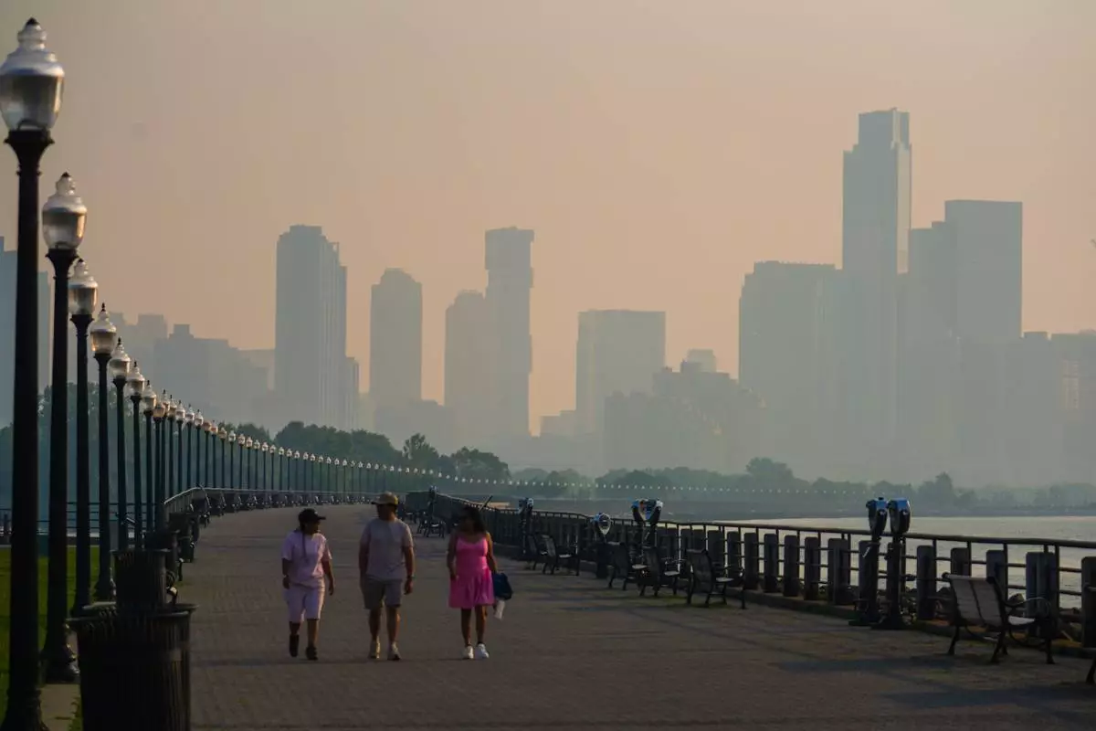 The Jersey City skyline is seen through a cover of wildfire smoke, in Jersey City, N.J., Friday, July 17, 2026. (AP Photo/Ryan Murphy)