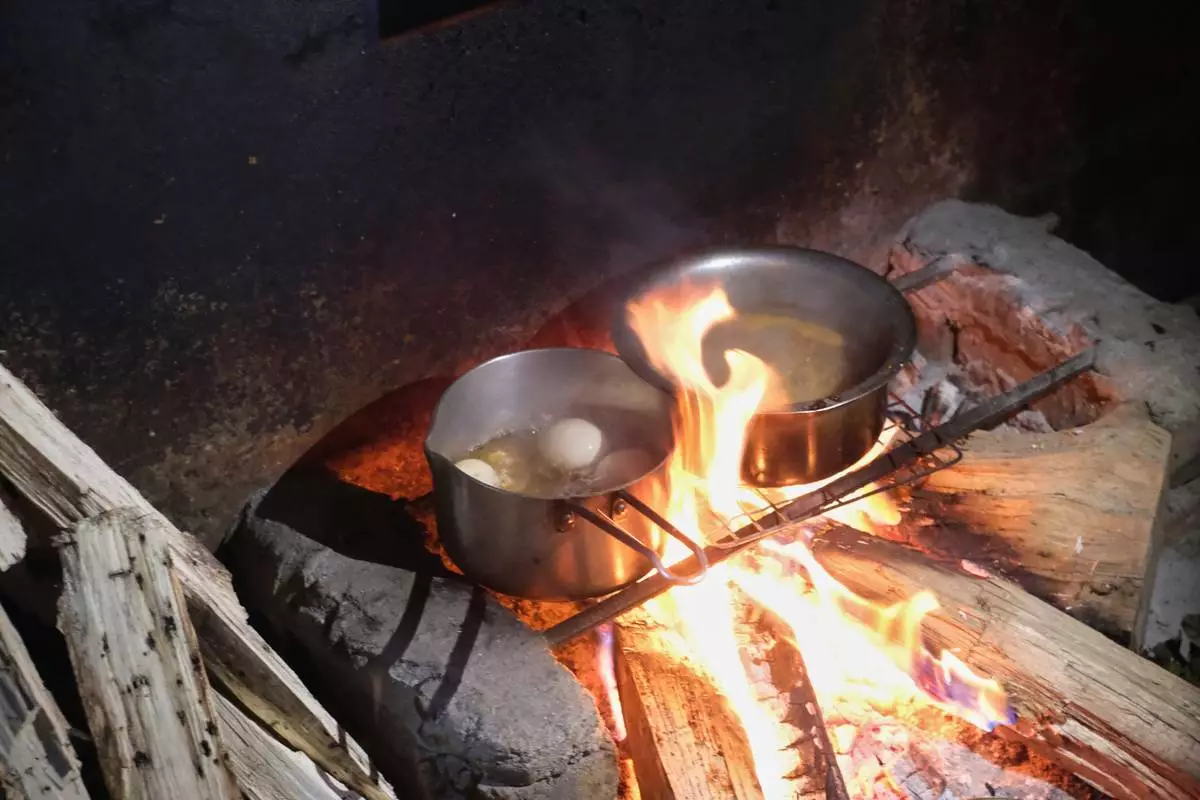 Eggs boil on a hearth in Kohima, capital of the northeastern Indian state of Nagaland, Monday, July 6, 2026. (AP Photo/Yirmiyan Arthur)