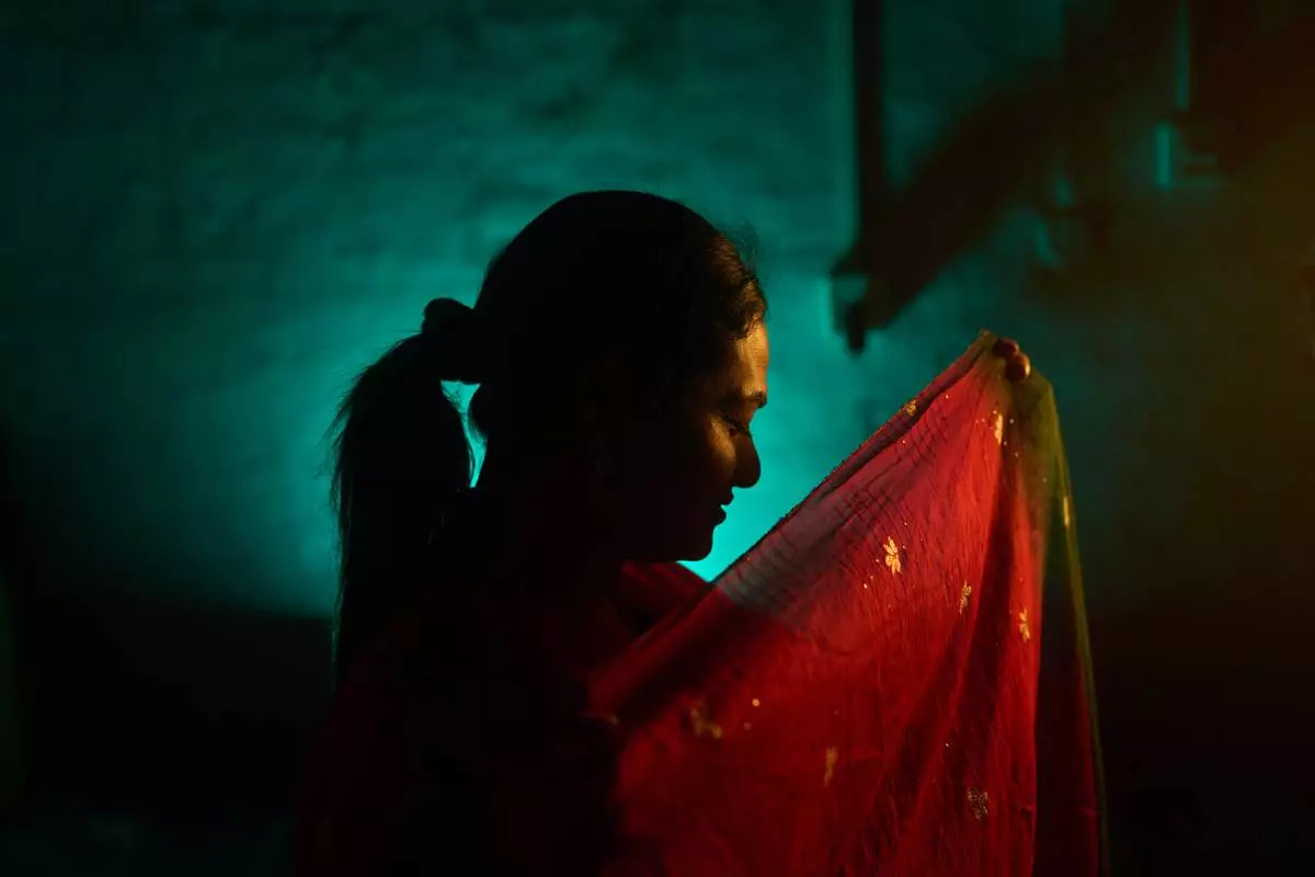 Sujata Chaudhary, who is transgender and a former aid worker who turned to sex work to survive after losing her job amid the U.S. foreign aid cuts, poses for a photo in Kathmandu, Nepal, Friday, May 22, 2026. (AP Photo/Bram Janssen)