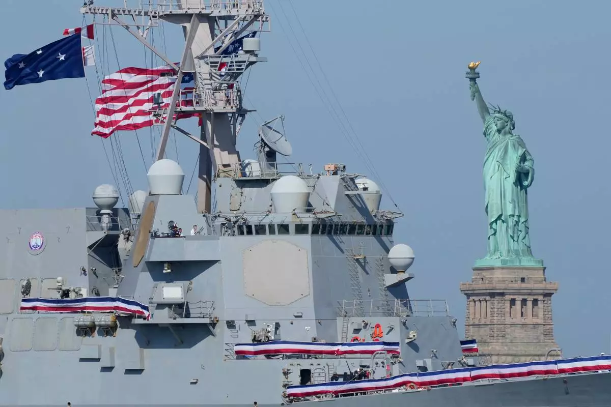 The USS Farragut sails past the Statue of Liberty in the New York harbor during The International Naval Review, ahead of Sail250, a gathering of tall ships and military ships, Saturday, July 4, 2026, in New York. (AP Photo/Yuki Iwamura)