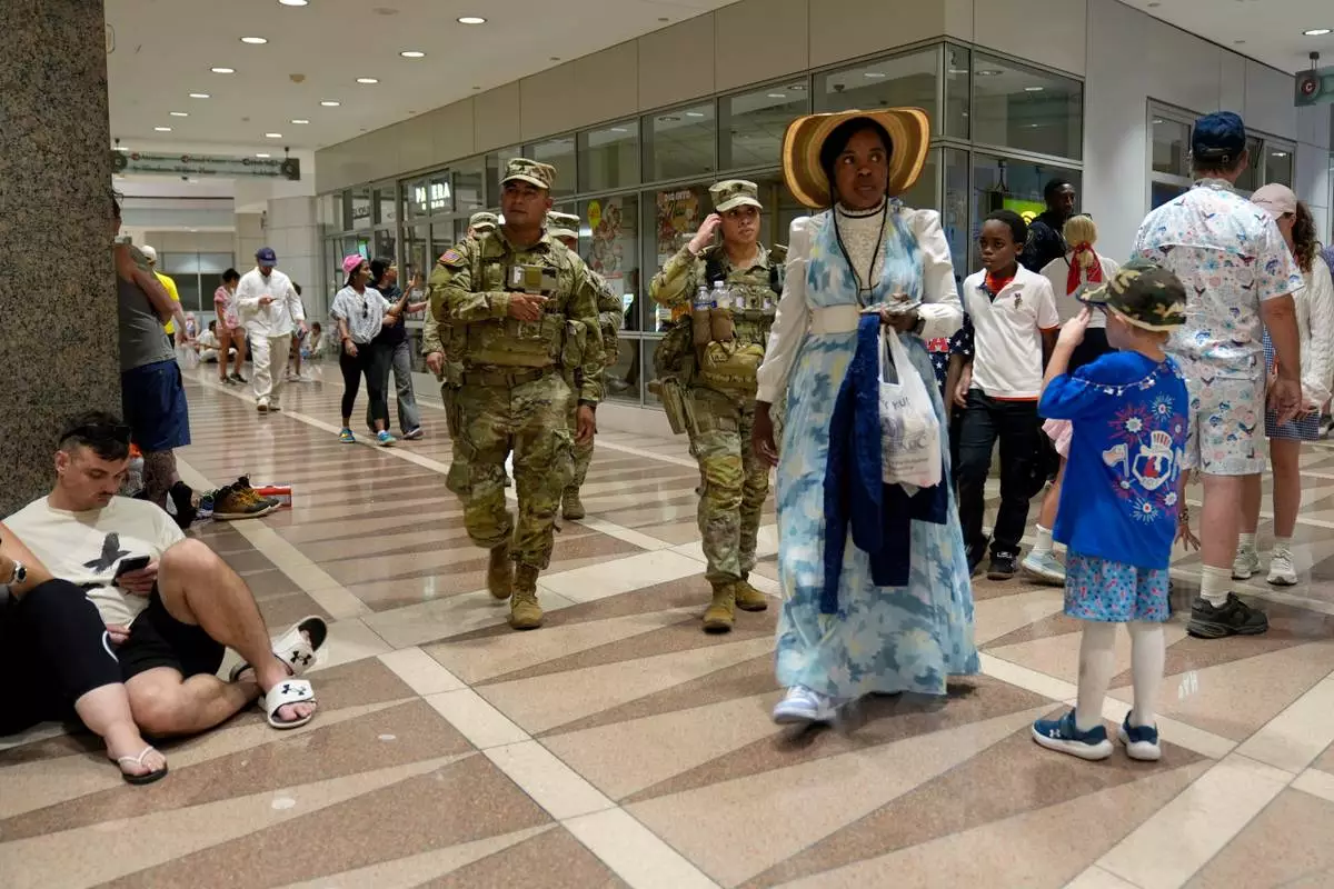 People take cover in the Ronald Reagan Federal Building after evacuating the National Mall due to weather while attending Independence Day events honoring the nation's 250th anniversary, Saturday, July 4, 2026, in Washington. (AP Photo/Pablo Martinez Monsivais)