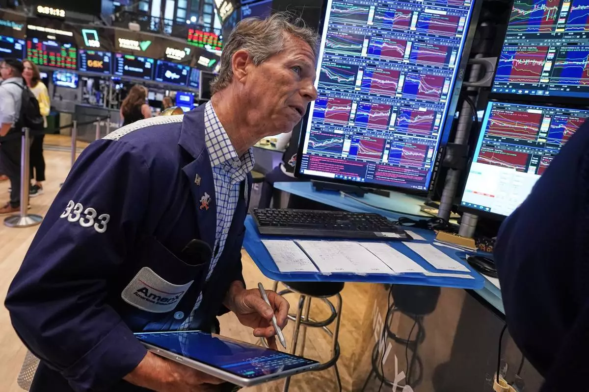 Trader Robert Charmak works on the floor of the New York Stock Exchange, Friday, June 26, 2026. (AP Photo/Richard Drew)