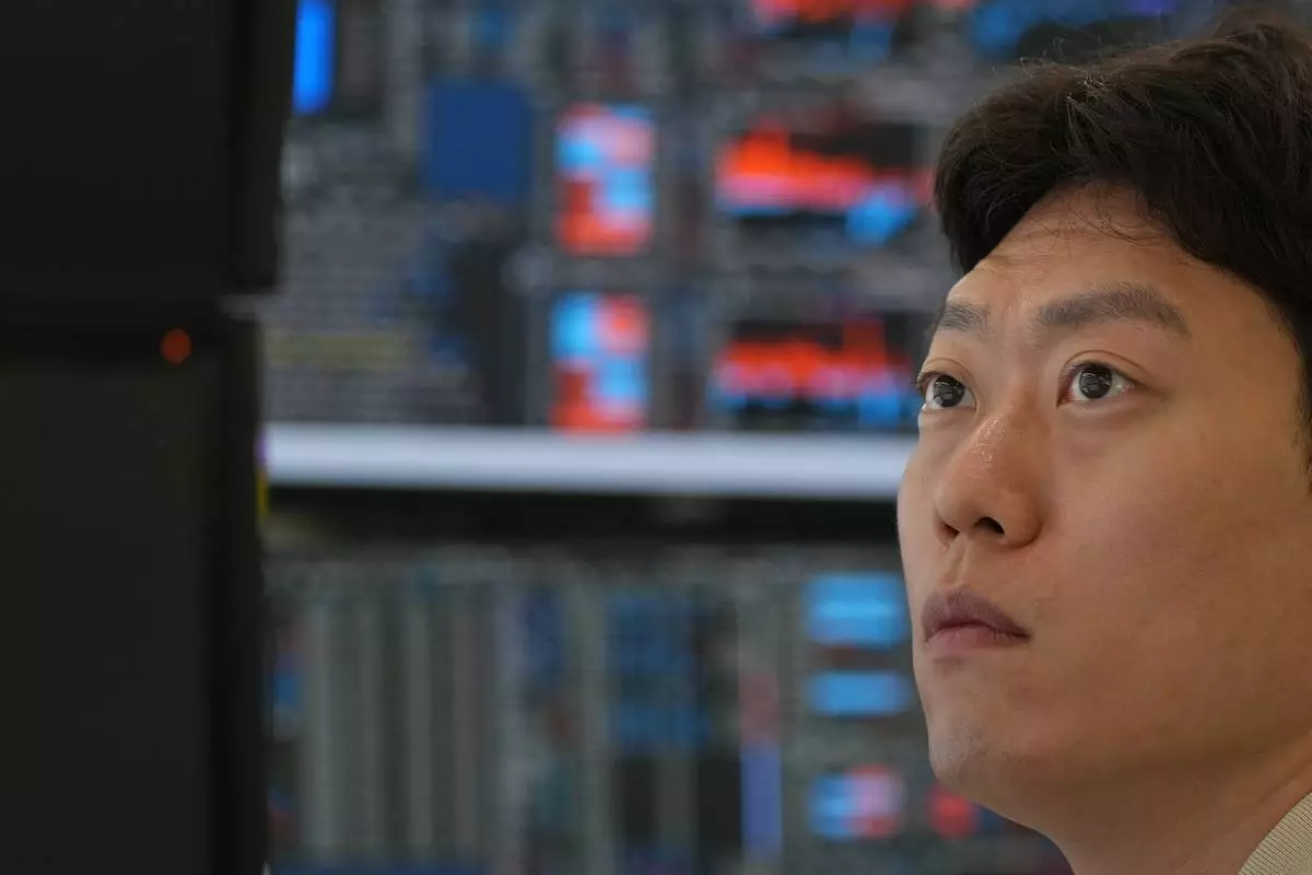 A dealer watches computer monitors at a dealing room of Hana Bank in Seoul, South Korea, Thursday, July 2, 2026. (AP Photo/Lee Jin-man)