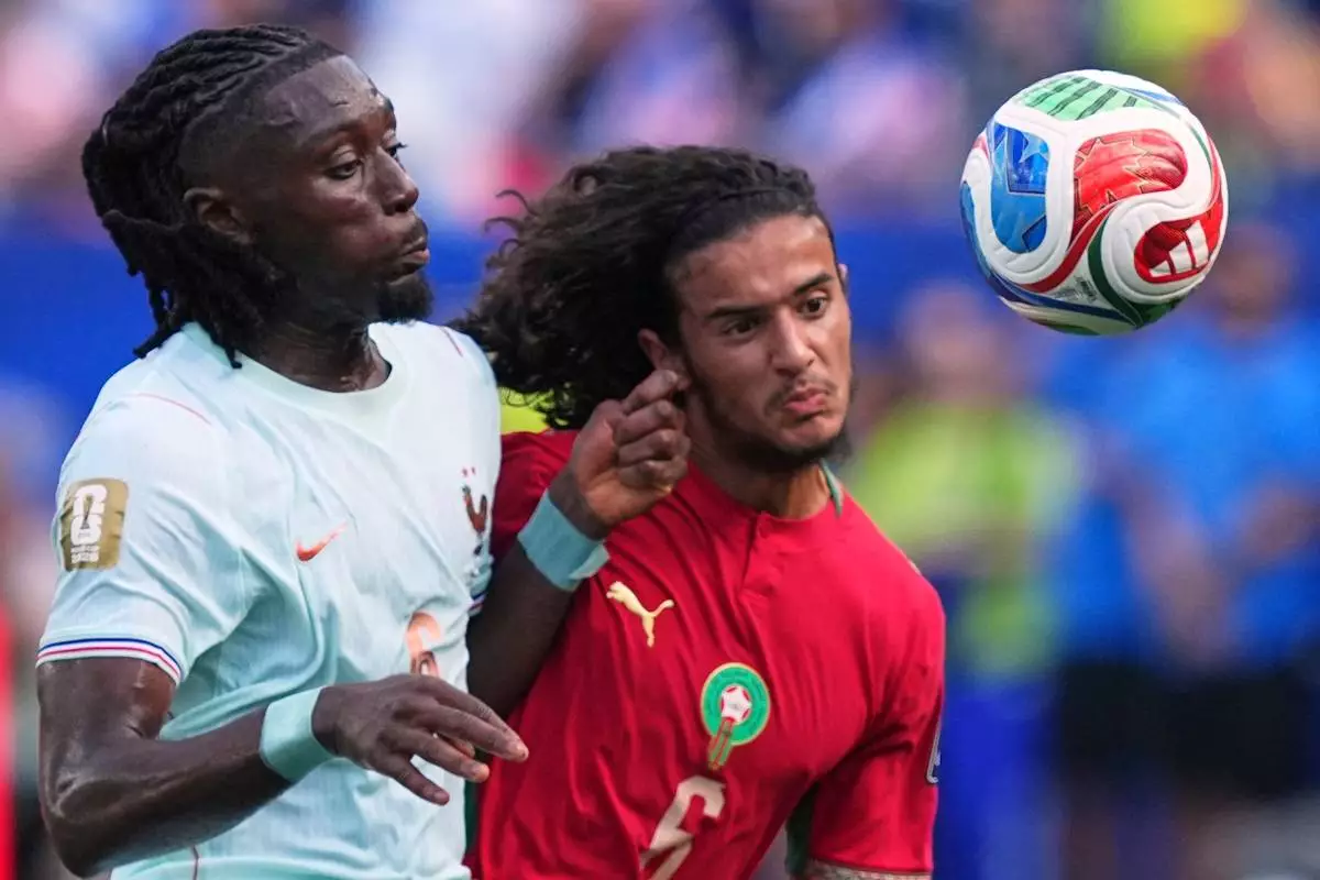 France's Manu Kone (6) and Morocco's Ayyoub Bouaddi (6) battle for the ball during the World Cup quarterfinal soccer match between France and Morocco in Foxborough, Mass., near Boston, Thursday, July 9, 2026. (AP Photo/Martin Meissner)