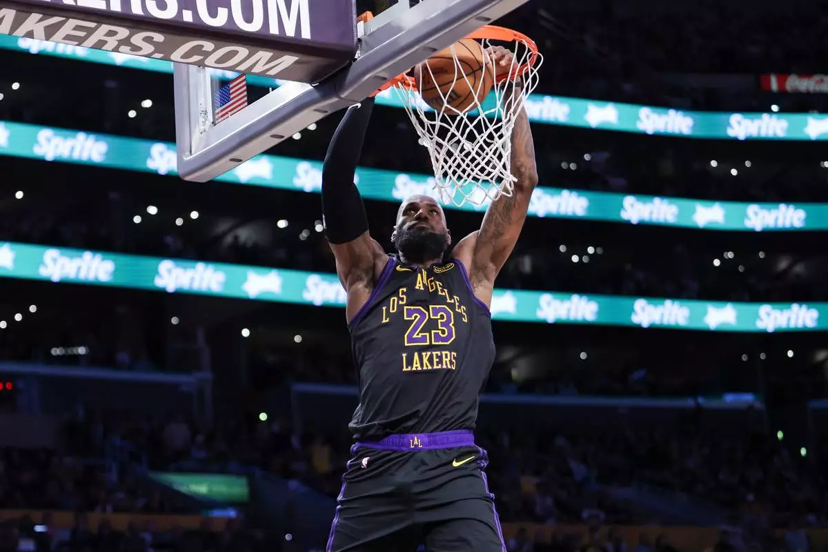 FILE - Los Angeles Lakers forward LeBron James (23) dunks against the Phoenix Suns during the second half of an NBA basketball game, April 10, 2026, in Los Angeles. (AP Photo/Jessie Alcheh, File)
