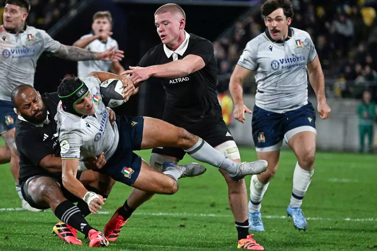 Juan Ignacio Brex, centre, of Italy is tackled New Zealand's George Bower and Anton Segner during the Nations Championship rugby international between the All Blacks and Italy in Wellington, New Zealand, Saturday, July 11, 2026. (Masanori Udagawa/Photosport via AP)