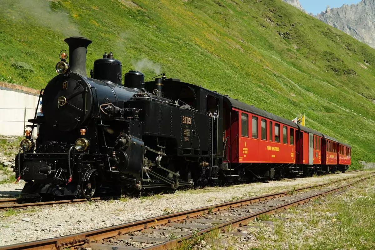 One of DFB's historic steam trains travels from Realp to Oberwald during a stop at the Furka station, Switzerland, Friday, June 26, 2026. (AP Photo/Niccolo Lupone)