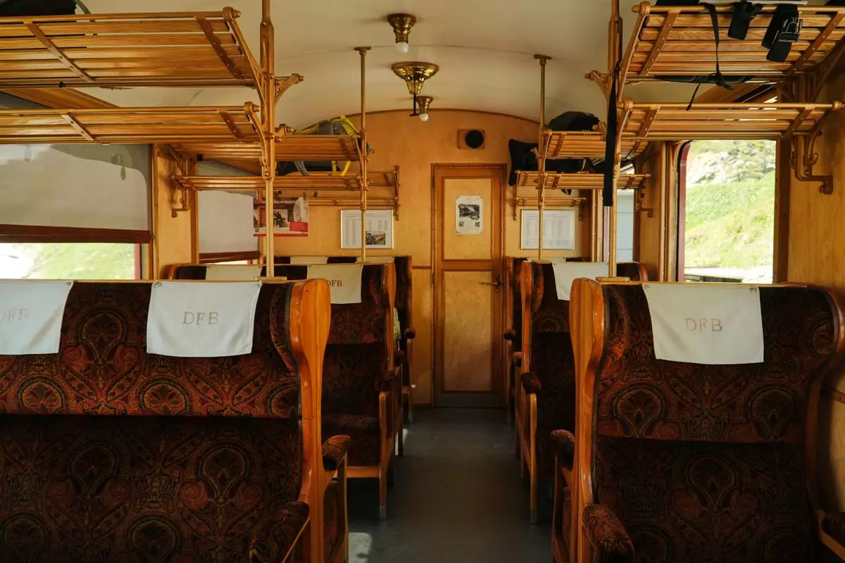 Interior view of a historic passenger carriage in service on the Furka railway during a stop at the Furka station near Realp, Switzerland, Friday, June 26, 2026. (AP Photo/Niccolo Lupone)