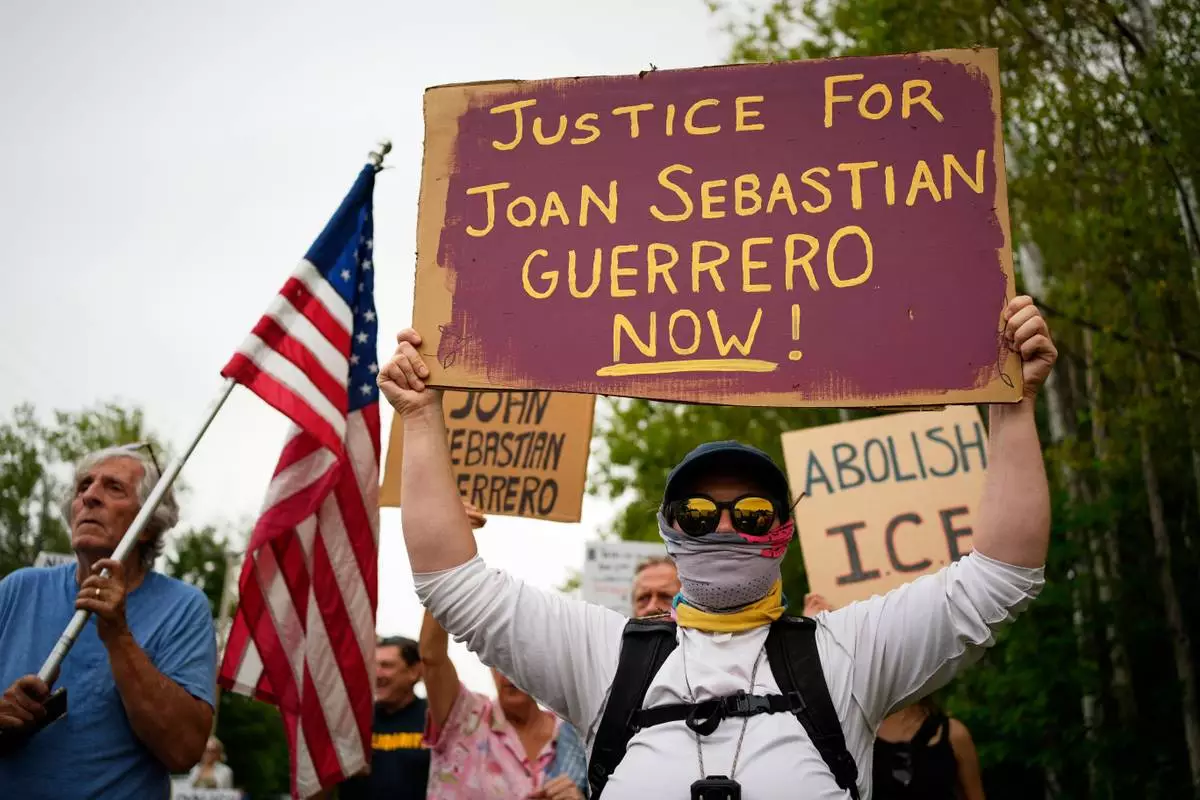 Protesters gather near a U.S. Immigration and Customs Enforcement facility Scarborough, Maine, one day after the shooting of Johan Sebastián Durán Guerrero, Tuesday, July 14, 2026. (AP Photo/Robert F. Bukaty) CORRECTION: Corrects ID to Johan Sebastián Durán Guerrero NOT Joan Sebastian Guerrero.