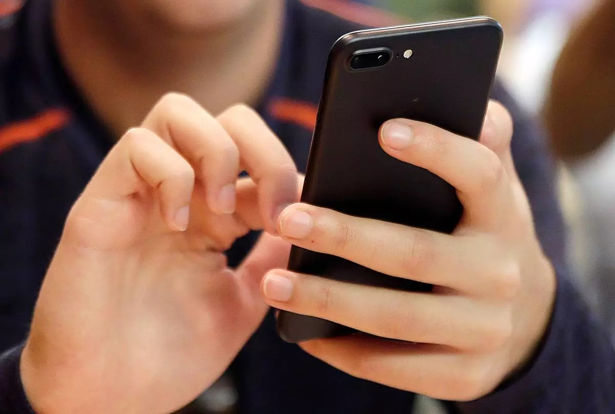 FILE - A person uses a smart phone in Chicago, Sept. 16, 2017. (AP Photo, File)