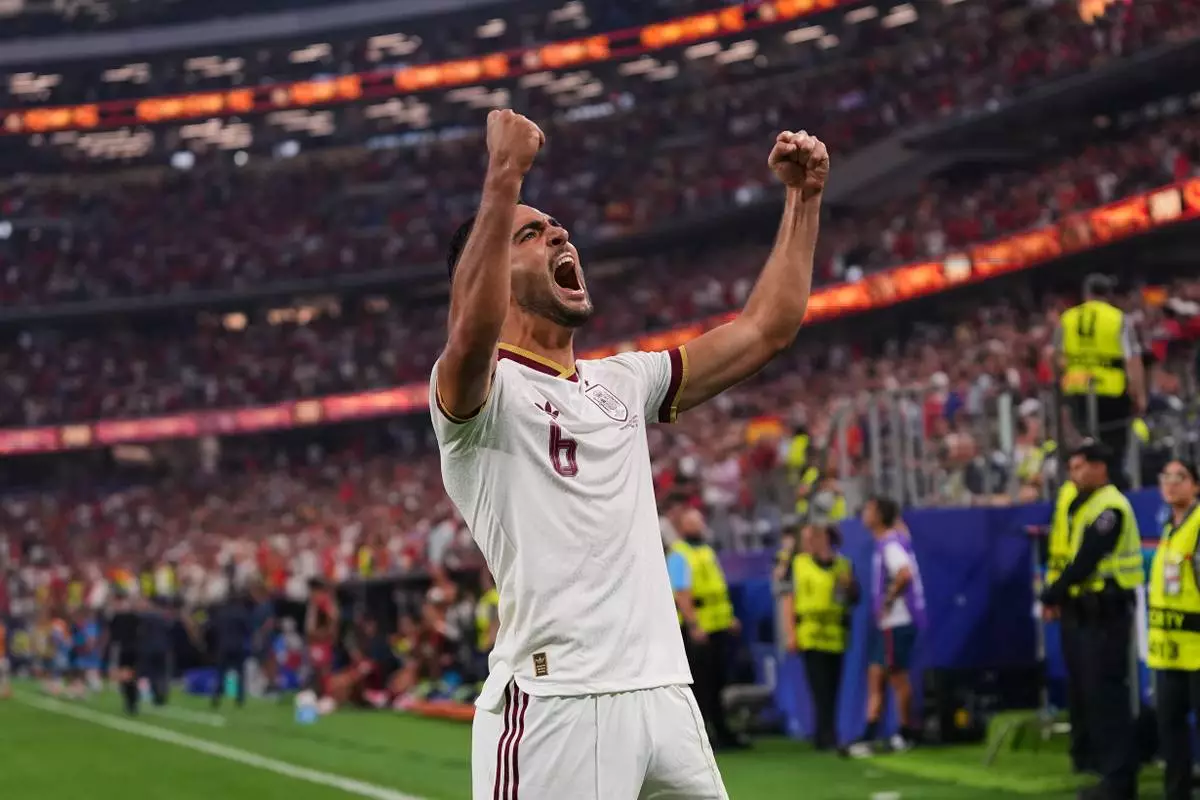 Spain's Mikel Merino (6) celebrates scoring his side's opening goal during the World Cup round of 16 soccer match between Portugal and Spain in Arlington, Texas, near Dallas, Monday, July 6, 2026. (AP Photo/Julio Cortez)