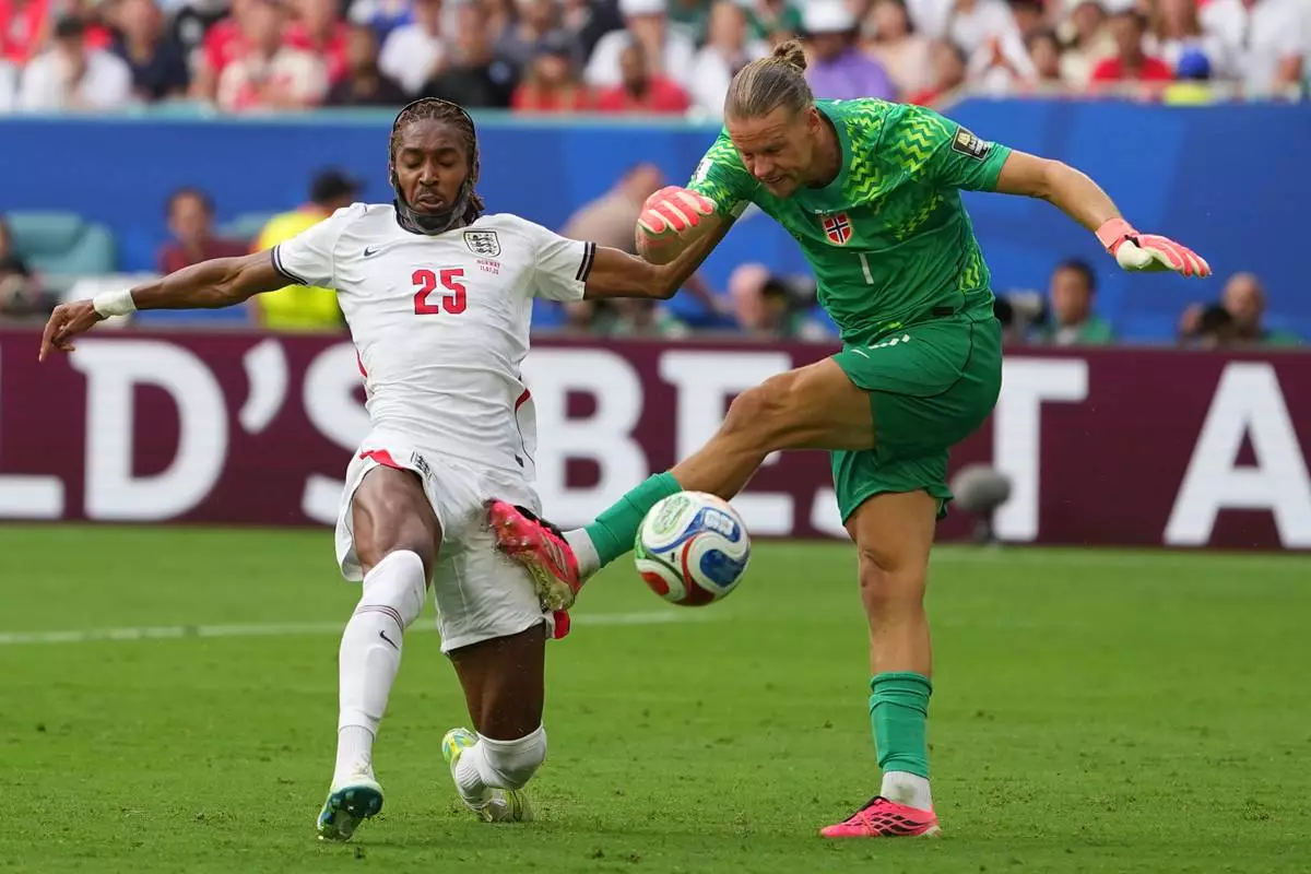 Norway goalkeeper Oerjan Nyland and England's Djed Spence vie for the ball during a World Cup quarterfinal soccer match in Miami Gardens, Fla., Saturday, July 11, 2026. (AP Photo/Julio Cortez)