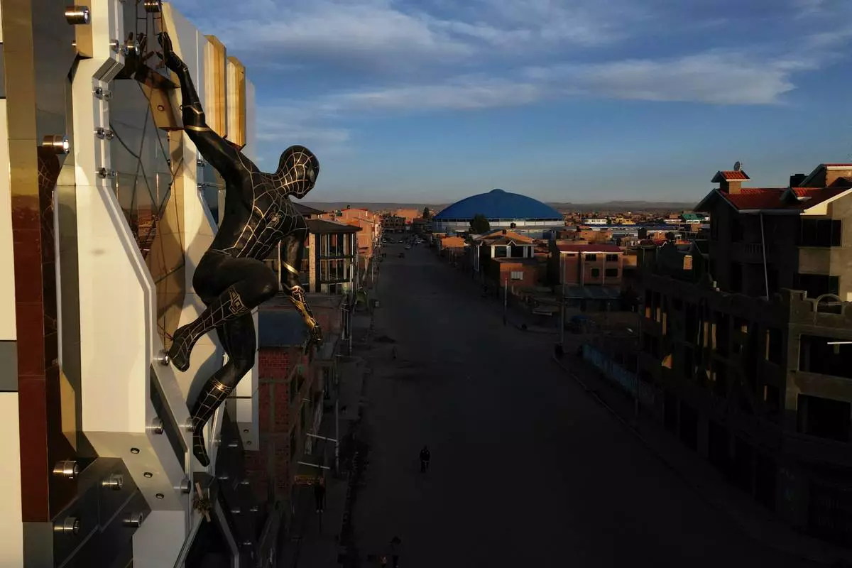 A Spiderman superhero statue decorates the Cholet building in El Alto, Bolivia, Tuesday, June 23, 2026. (AP Photo/Juan Karita)