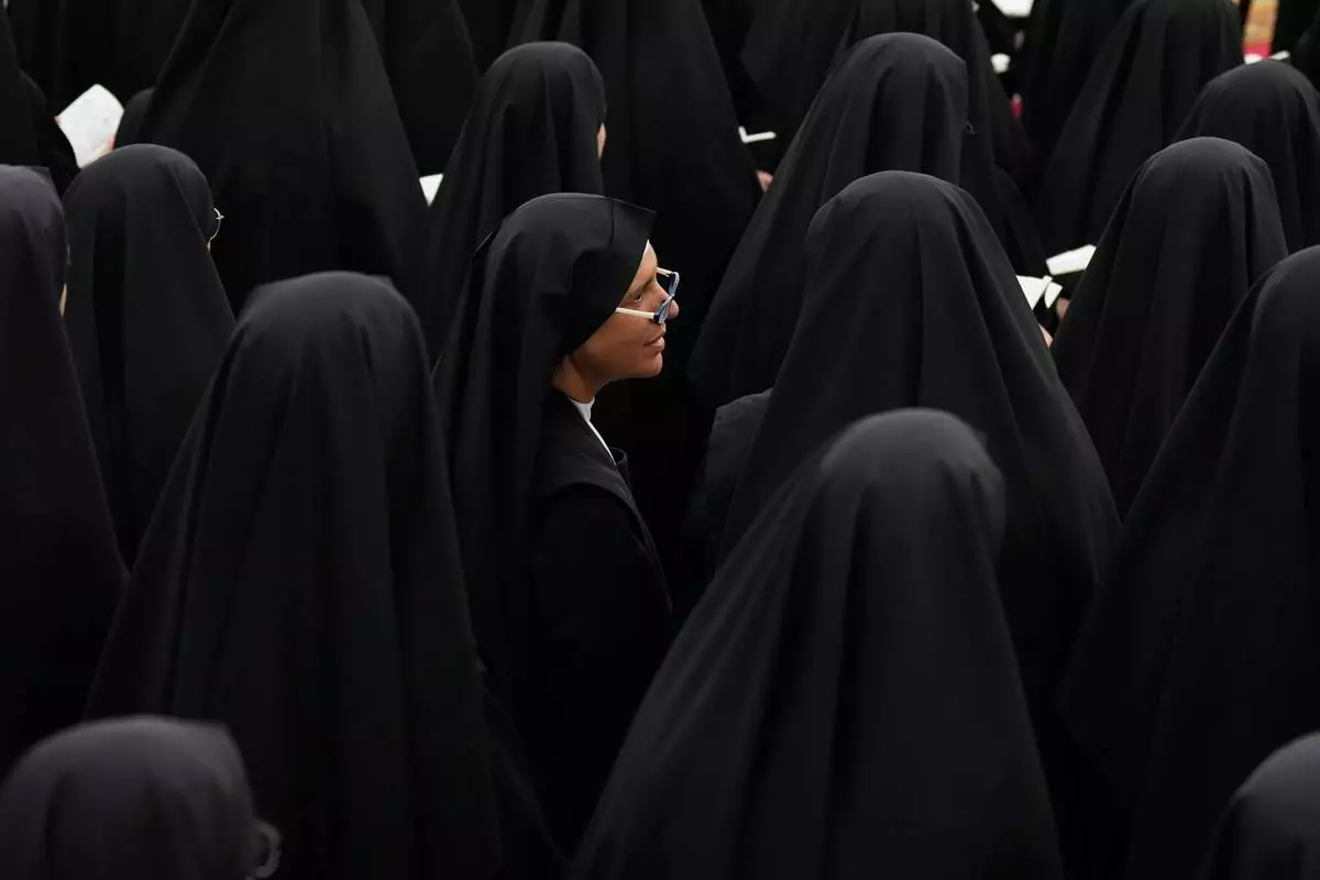 Nuns attend a consecration ceremony for four new bishops in a tent set up outside the Society of St. Pius X seminary, in Econe, Switzerland, Wednesday, July 1, 2026. (AP Photo/Baz Ratner)