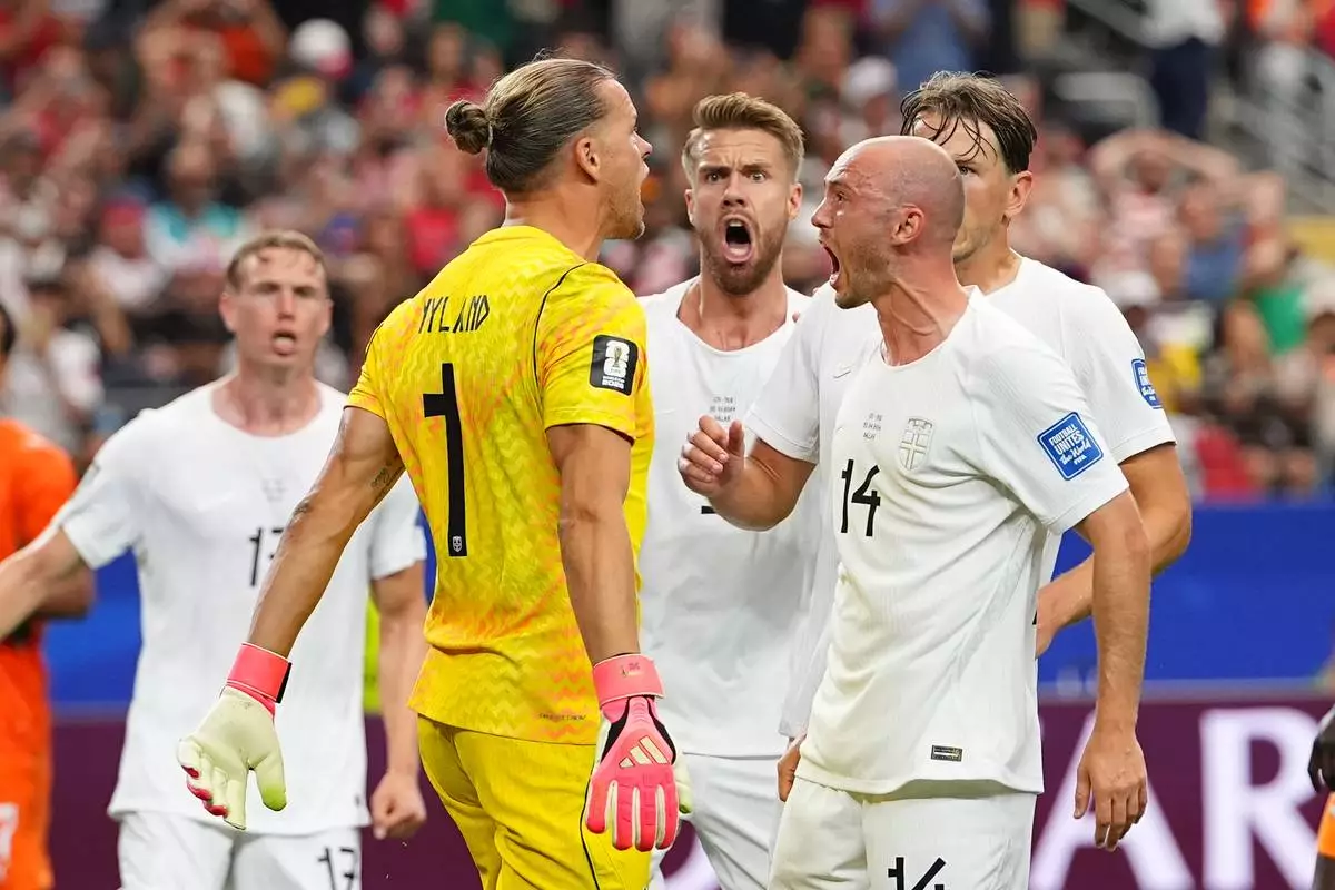 Norway goalkeeper Oerjan Nyland (1) and Norway's Fredrik Aursnes (14) react during the World Cup round of 32 soccer match between Ivory Coast and Norway in Arlington, Texas, near Dallas, Tuesday, June 30, 2026. (AP Photo/Julio Cortez)