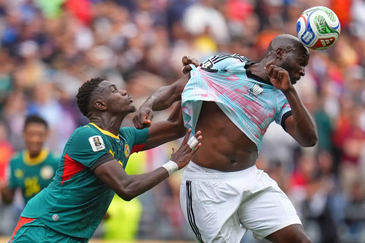 Senegal's Iliman Ndiaye (13) pulls Belgium's Romelu Lukaku (9) during the World Cup round of 32 soccer match between Belgium and Senegal in Seattle, Wednesday, July 1, 2026. (AP Photo/Manu Fernandez)