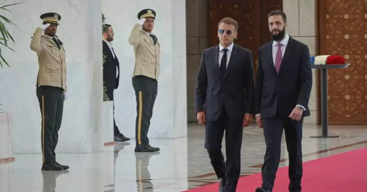 Explosions rock Damascus, wounding 18, as French President Macron visits Syria