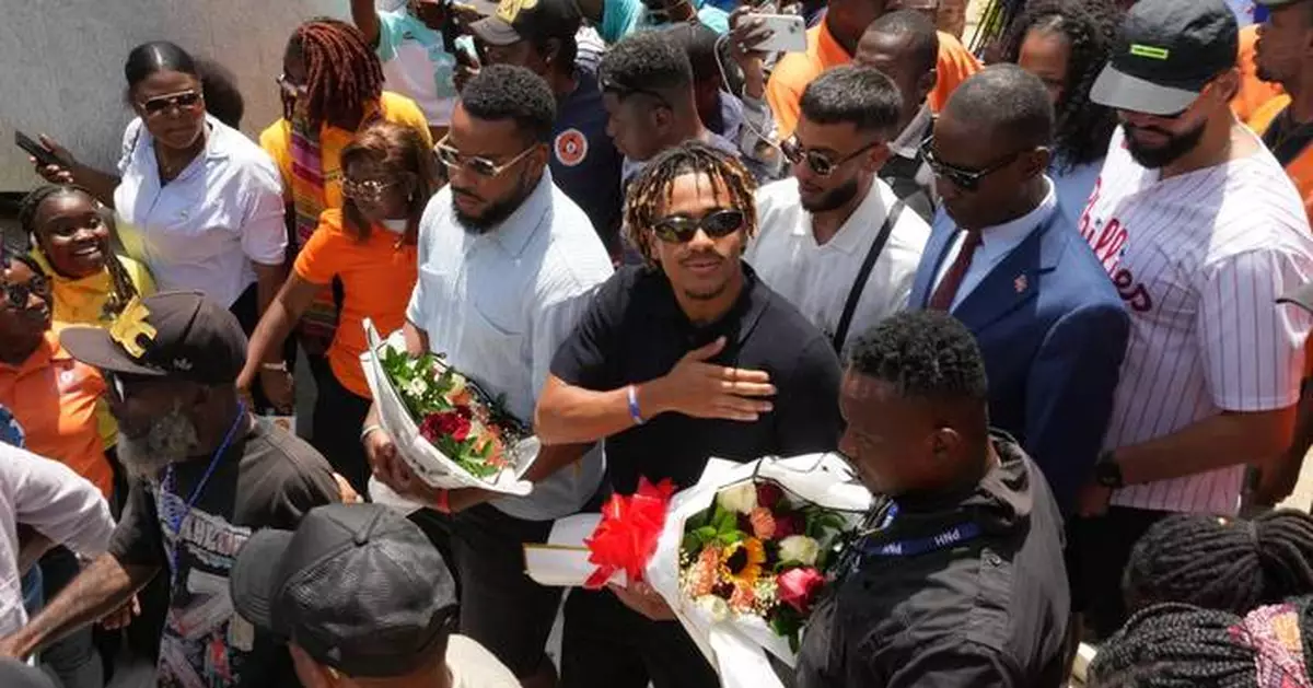 Members of Haiti's national soccer team tour their capital after playing in the World Cup