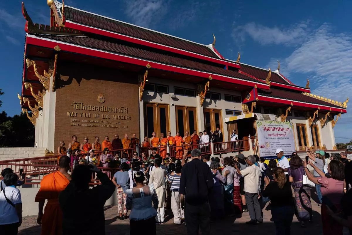 Bhikkhu Pannakara, a Buddhist monk who led a Walk for Peace from Fort Worth, Texas, to Washington, D.C., and fellow monks take group pictures at Wat Thai of Los Angeles in the North Hollywood section of Los Angeles, Monday, July 13, 2026.(AP Photo/Jae C. Hong)