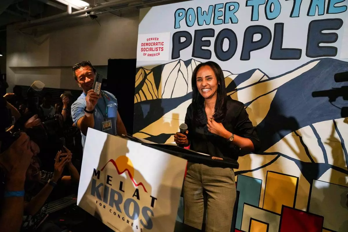 Democratic congressional candidate Melat Kiros stands on stage as supporters cheer after she won the Democratic nomination during a primary election night watch party at The Broadway, Tuesday, June 30, 2026, in Denver. (AP Photo/Rebecca Slezak)