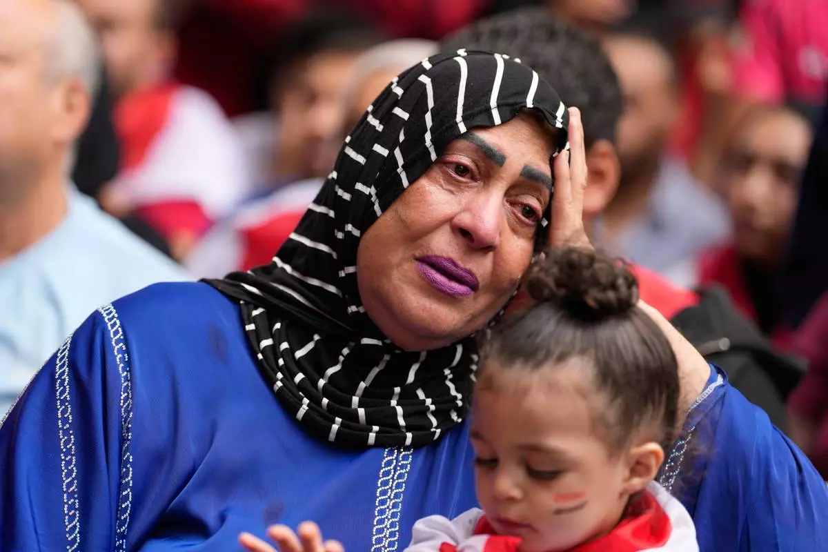 Faten Moussa becomes emotional as she watches the end of a World Cup soccer game between Egypt and Argentina, in New York, Tuesday, July 7, 2026. (AP Photo/Seth Wenig)